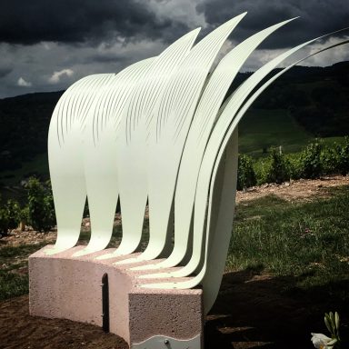 Assise réalisée en acier et béton, peinture phosphorescente, pièces uniques. 7 pétales en acier surmonte bloc de béton couleur granit rose